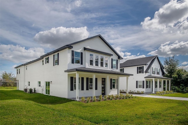 view of front facade with a front yard and cooling unit