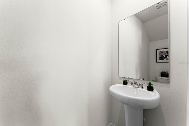 bathroom featuring visible vents and a sink