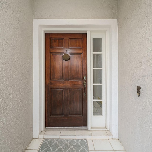 view of exterior entry featuring stucco siding