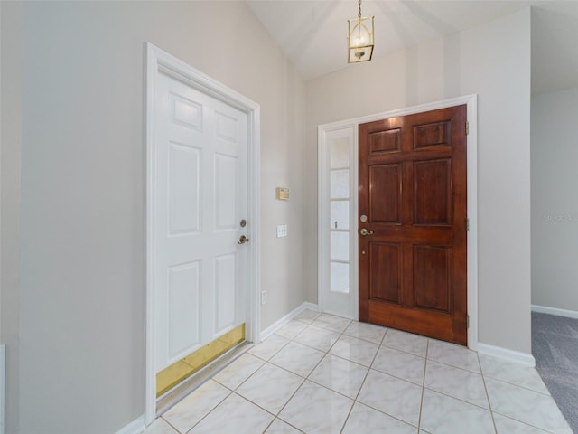 foyer featuring light tile patterned floors and baseboards