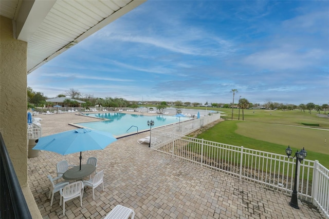 pool featuring a patio and fence