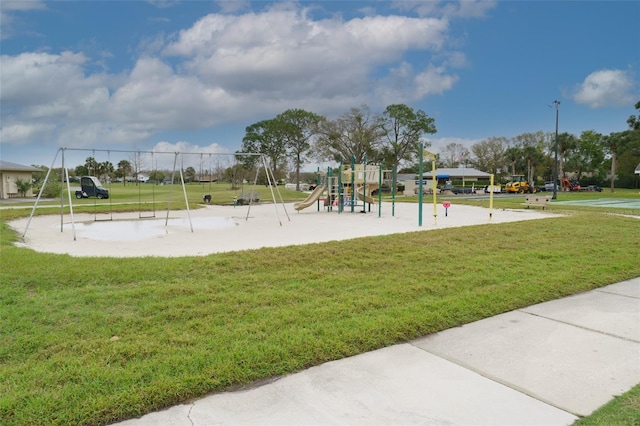 view of home's community with playground community and a yard