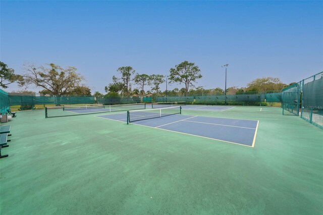 view of sport court featuring fence