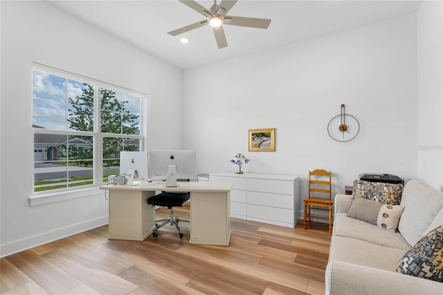 home office featuring light wood finished floors, ceiling fan, baseboards, and recessed lighting