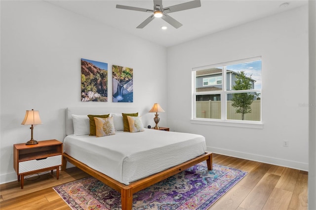 bedroom with baseboards, recessed lighting, a ceiling fan, and light wood-style floors