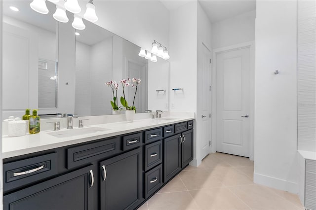 full bath with double vanity, a sink, and tile patterned floors