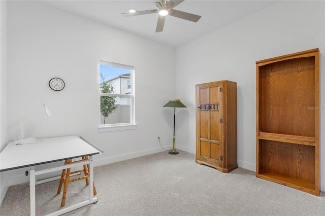 office space featuring carpet floors, ceiling fan, and baseboards