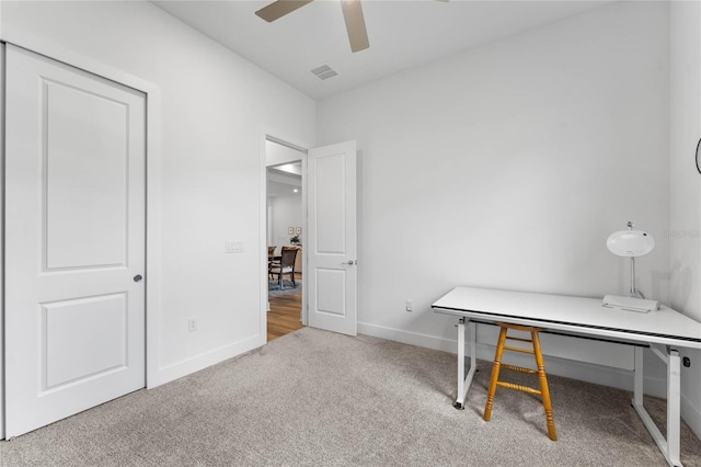 office space with carpet flooring, ceiling fan, visible vents, and baseboards