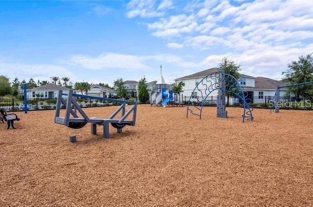 community jungle gym featuring a residential view and fence