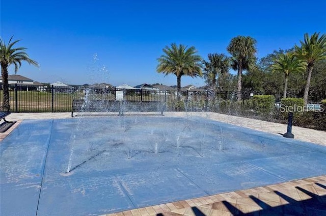 view of swimming pool featuring fence