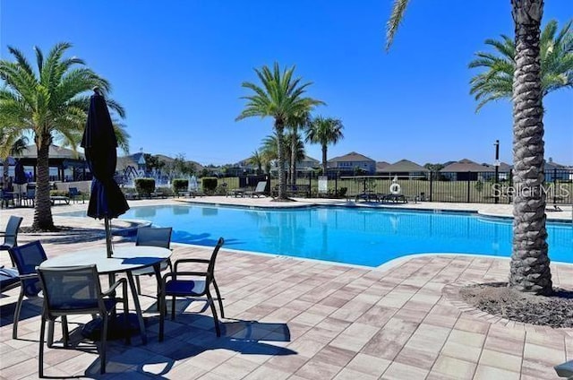 pool featuring a patio area and fence