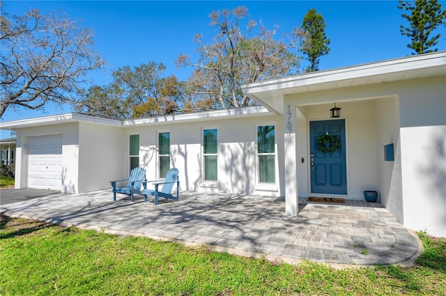 exterior space with an attached garage and stucco siding