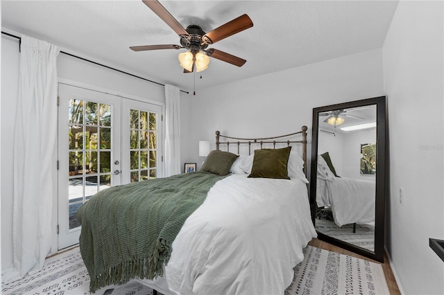 bedroom with access to exterior, a ceiling fan, french doors, and wood finished floors