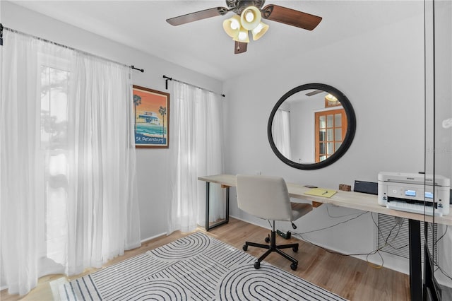 home office featuring light wood-style flooring and ceiling fan