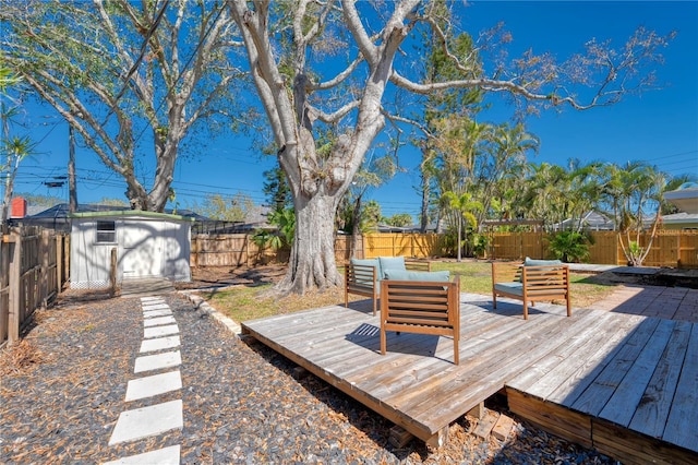 exterior space with a fenced backyard, a storage unit, an outdoor living space, and an outbuilding