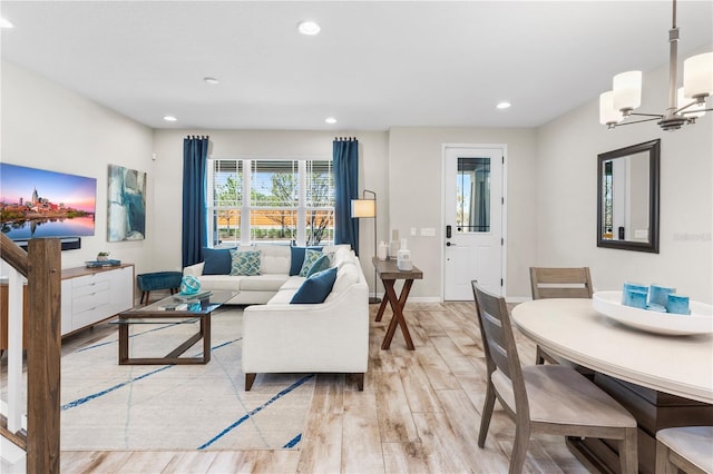 living area with a chandelier, light wood finished floors, baseboards, and recessed lighting