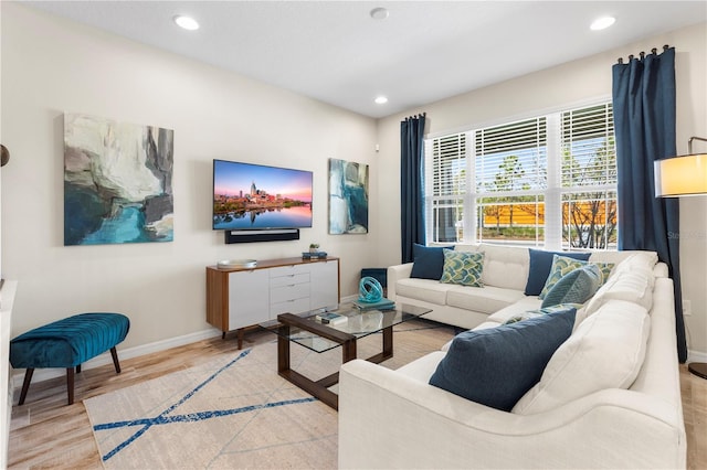 living area featuring light wood finished floors, recessed lighting, and baseboards