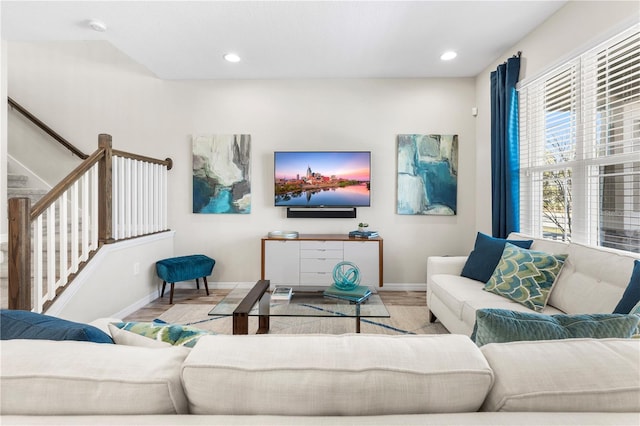 living area featuring stairway, recessed lighting, wood finished floors, and baseboards