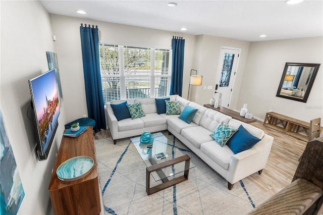 living area featuring recessed lighting, baseboards, and wood finished floors