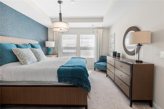 bedroom with light carpet and baseboards