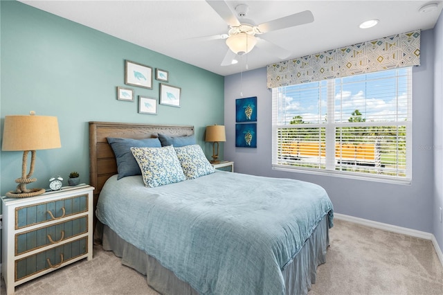 carpeted bedroom featuring ceiling fan and baseboards