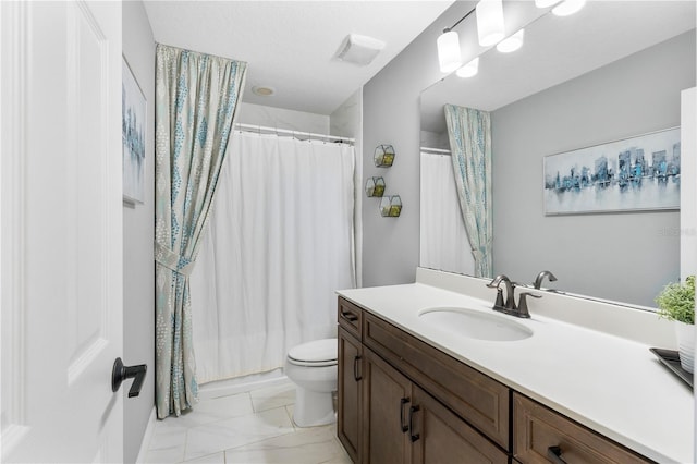 bathroom featuring toilet, marble finish floor, curtained shower, and vanity