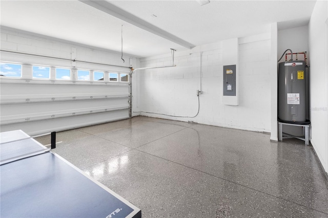 garage featuring electric panel, water heater, and concrete block wall