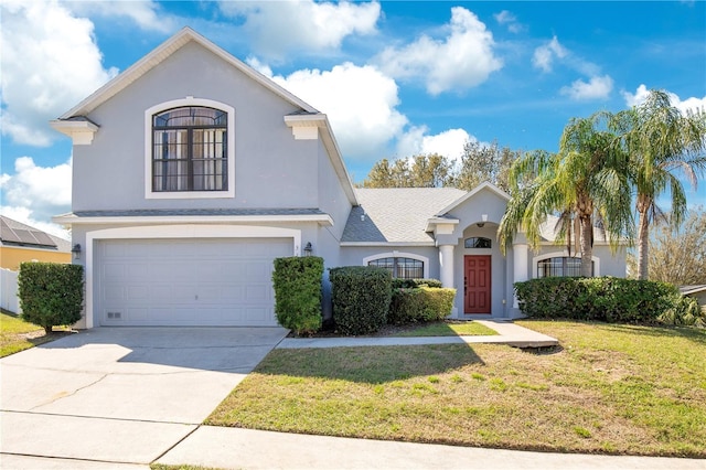 view of front of property featuring stucco siding, driveway, a garage, and a front yard