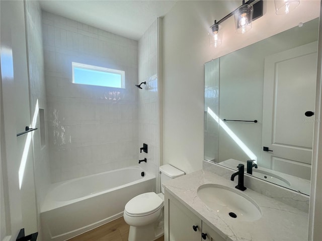 full bathroom with wood finished floors, shower / bathing tub combination, vanity, and toilet