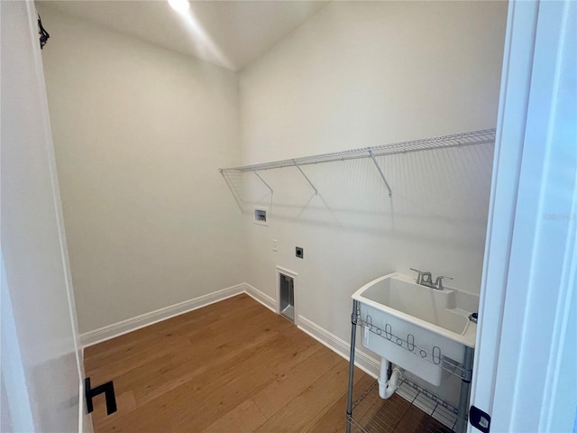 laundry area with washer hookup, hookup for an electric dryer, wood finished floors, laundry area, and baseboards