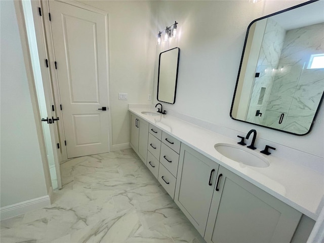 bathroom with double vanity, marble finish floor, a marble finish shower, and a sink