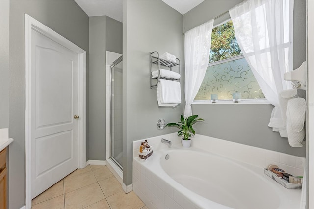 bathroom with a stall shower, vanity, a bath, and tile patterned floors