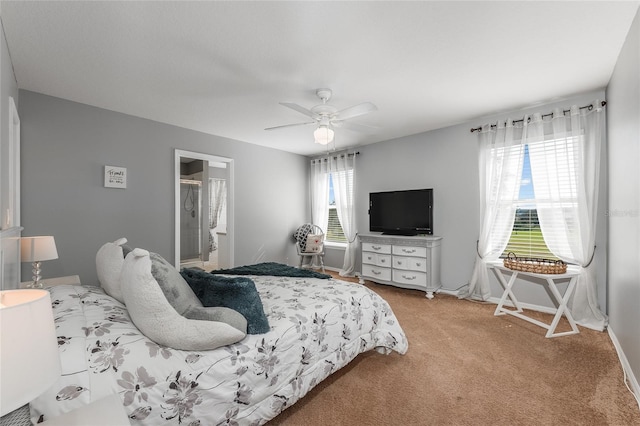 bedroom featuring a ceiling fan, carpet flooring, ensuite bath, and baseboards