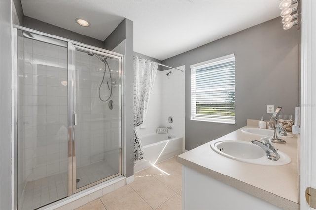 full bathroom featuring a tile shower, double vanity, a sink, and tile patterned floors