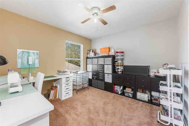 carpeted office space with ceiling fan