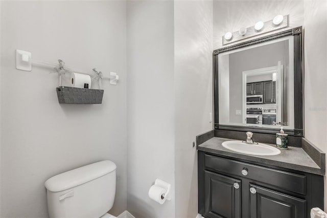 bathroom with toilet and vanity