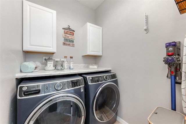 laundry room with cabinet space and washer and clothes dryer