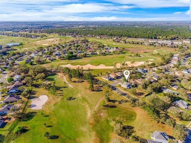 drone / aerial view with golf course view and a residential view