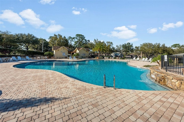 pool featuring a patio and fence