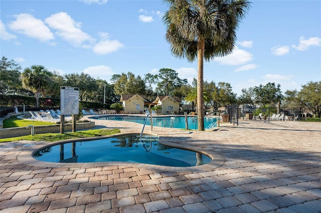 pool with fence and a patio