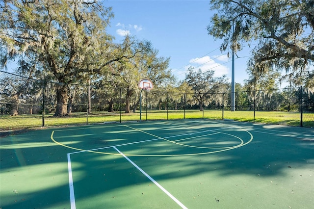 view of basketball court with community basketball court and fence