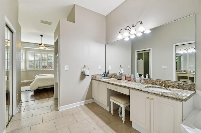 ensuite bathroom with double vanity, visible vents, connected bathroom, a sink, and tile patterned flooring