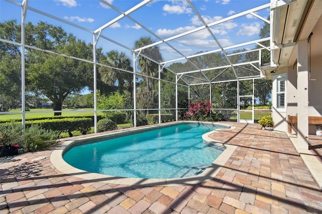 pool featuring a patio and glass enclosure