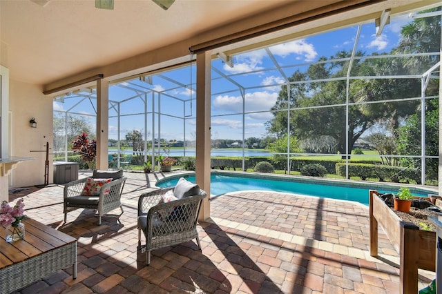 view of patio with glass enclosure and an outdoor pool