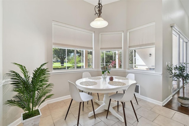 dining area with light tile patterned floors and baseboards