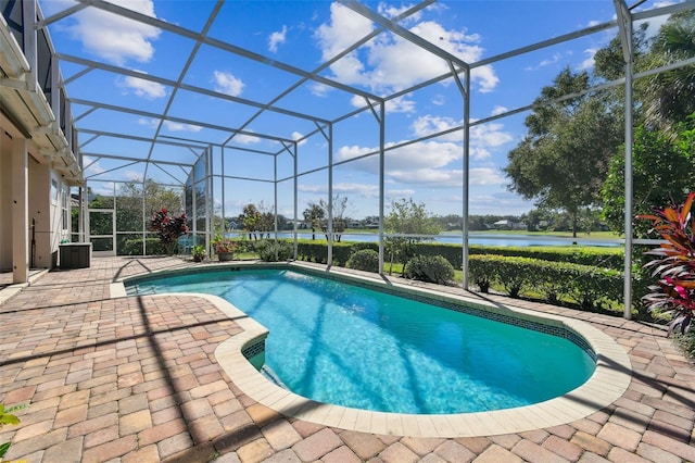 outdoor pool featuring a patio area, a lanai, and a water view