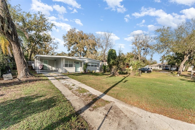 view of front of property with a carport, driveway, a front lawn, and a porch