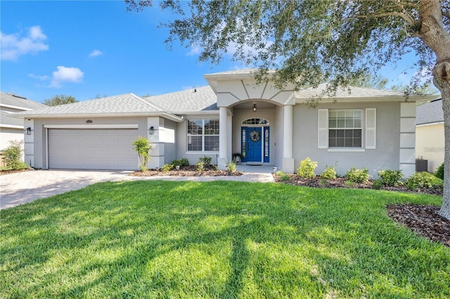 ranch-style house with an attached garage, a front lawn, decorative driveway, and stucco siding