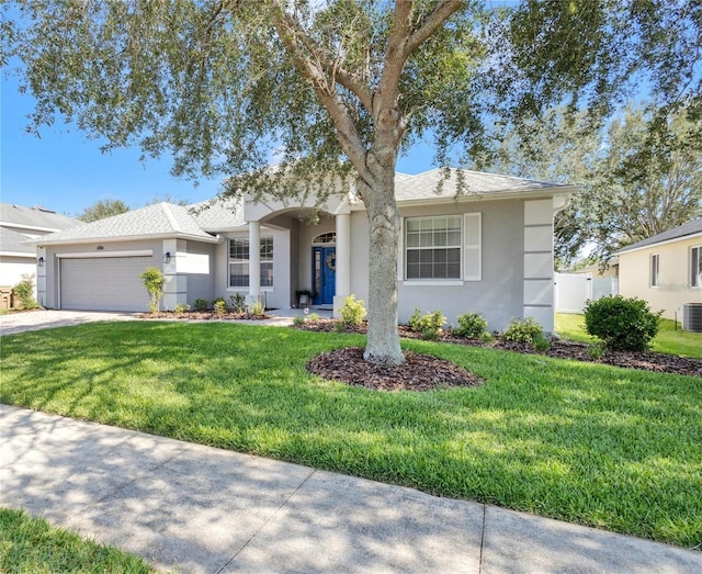 single story home with stucco siding, an attached garage, central AC unit, driveway, and a front lawn