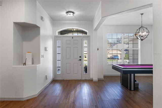 foyer featuring an inviting chandelier, billiards, baseboards, and wood finished floors